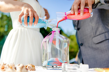 Newlyweds during sand ceremony © Alex Tihonov