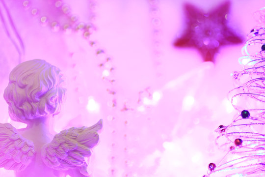 Christmas background of bokeh lights with an angel and a star