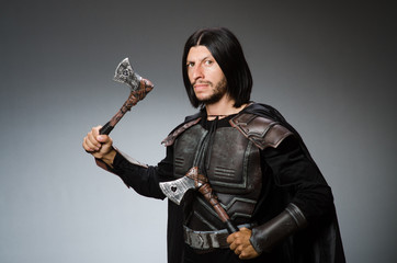 Knight with axe against dark background