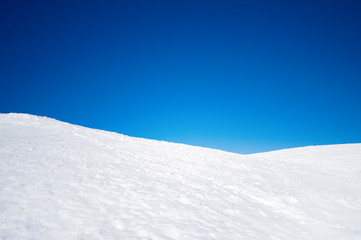 White snowy fields under a blue sky