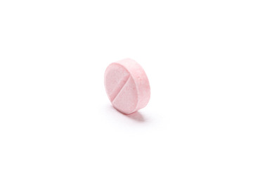 Pink tablet, isolated on white. Healthcare concept