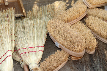 Fototapeta na wymiar old brooms, brushes and natural material for sale to the market