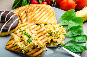 Healthy breakfast scrambled eggs with chive, panini toast