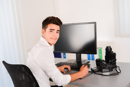 handsome young man editing photography with graphic tablet