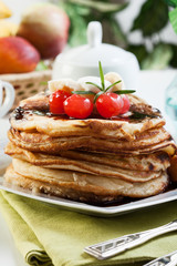 Pancakes with chocolate sauce fruit and coffee