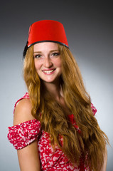 Woman wearing red fez hat