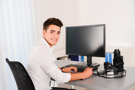 handsome young man editing photography with graphic tablet