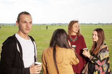 Group of young people having a picnic in the park