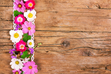 Flowers on wood, space for text
