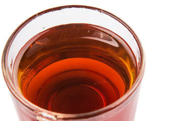 Honey in glass jar over white background