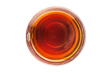 Honey in glass jar over white background