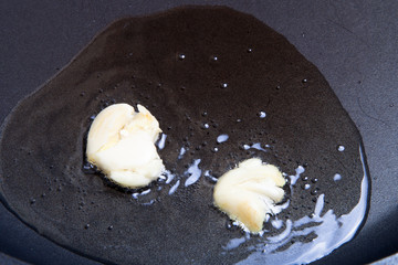 crushed garlic roasted in hot oil in a frying pan