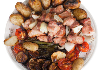 Meat with potatoes, eggplants, tomatoes, onions and peppers on t