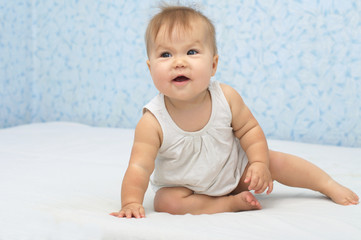 Happy baby smiling on bed