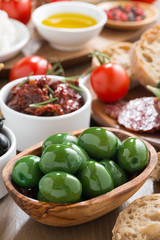 assorted Italian antipasti - olives, pickles and bread, close-up