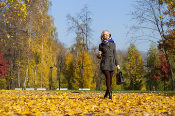 Young woman walking in autumn park