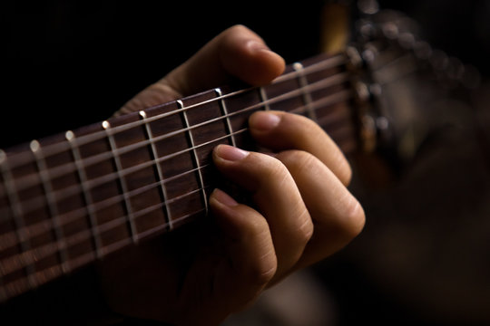 The Hand Of Man Playing Guitar Closeup