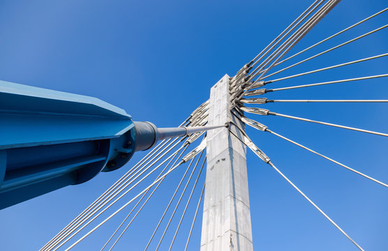 Fototapeta Modern cable bridge pylon against blue sky