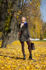 Young woman walking in autumn park