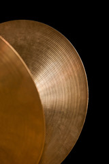 Detail of orchestral cymbals on a black background