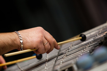Human hands playing a glockenspiel closeup