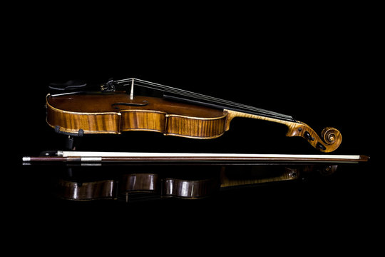 Violin lying on a black background