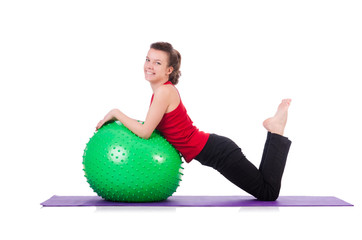 Young woman exercising with swiss ball