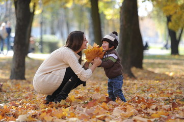 mother and the little son together walk in the park