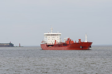 Fototapeta premium Cargo ship sailing in still water.