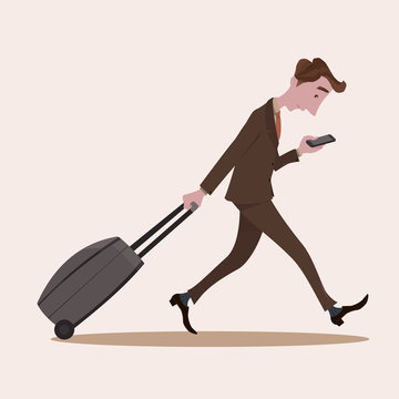 Young business man pulling the luggage busy with mobile phone.