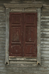 Obraz na płótnie Canvas The old shabby wood closed window by shutters
