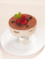 Tiramisu cake in glass with small fruits