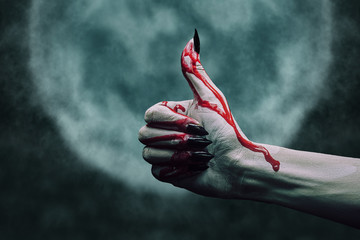 Vampire bloody hand with thumb up gesture