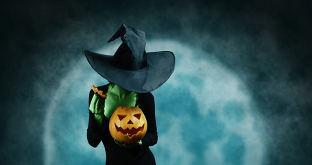 Green witch with pumpkin