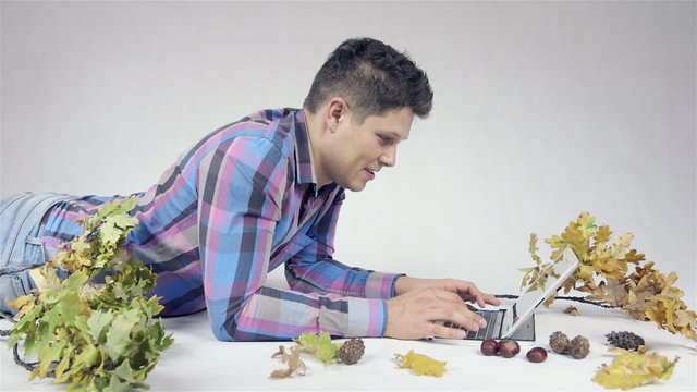 Handsome man using tablet in studio, over white background