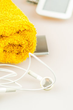 headphones, mp3 and orange towel symbols of modern lifestyle