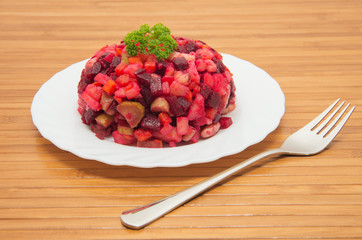 Vegetable salad with beets on table ready for eat