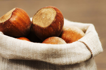 Closeup view of hazelnuts on a wooden table