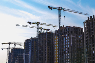 Fototapeta na wymiar Building cranes on construction