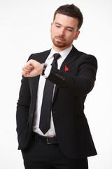 Businessman in a suit looking at his watch