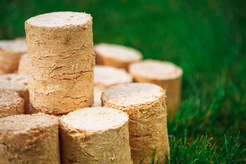 wooden pellets on green grass background