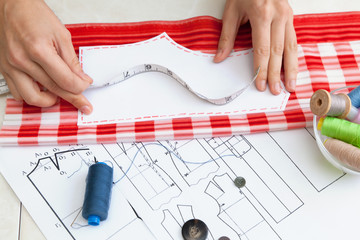 A tailor is laying out a dress/Sewing layout