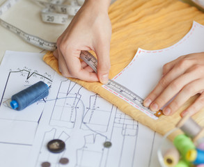 A tailor is laying out a dress/Sewing layout