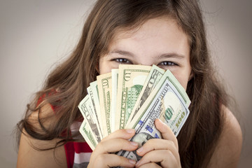 Beautiful teen girl holding money