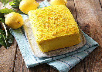 Tasty lemon cake on wooden table