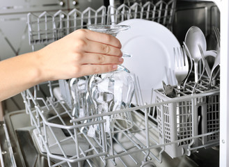 Open dishwasher with clean utensils in it