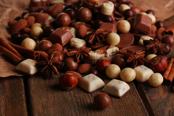 Different kinds of chocolates on wooden table close-up