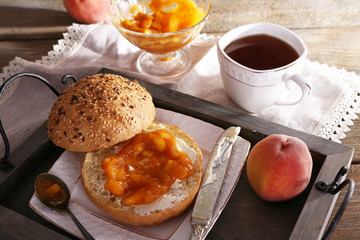 light breakfast with cup of tea and homemade jam on wooden