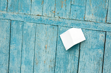 Sheet of Paper on Old Blue Wooden Background.