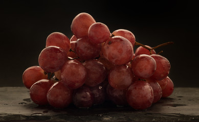 red grapes over slate plate